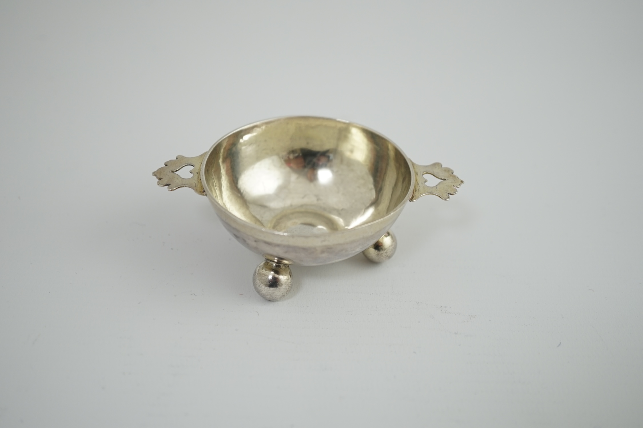 A late 17th century? German Nurnberg silver two handled wine taster, on three ball feet